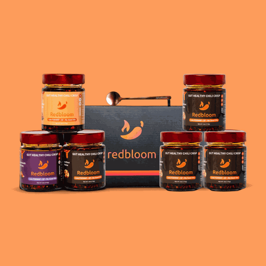The entire set of gut-healthy best chili crisp jars with spicy heat level icons and branded box